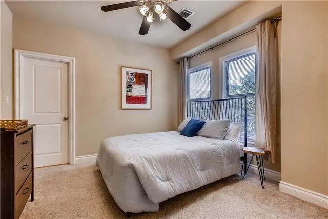 a bedroom with a large bed and a window