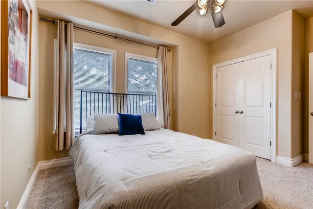 a bedroom with a large bed and a window