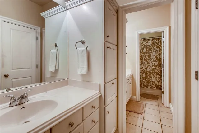 a bathroom with a shower sink and mirror