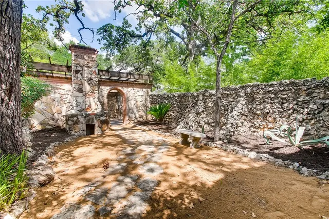 a backyard of a house with table and chairs