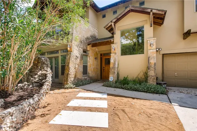 a front view of a house with garden