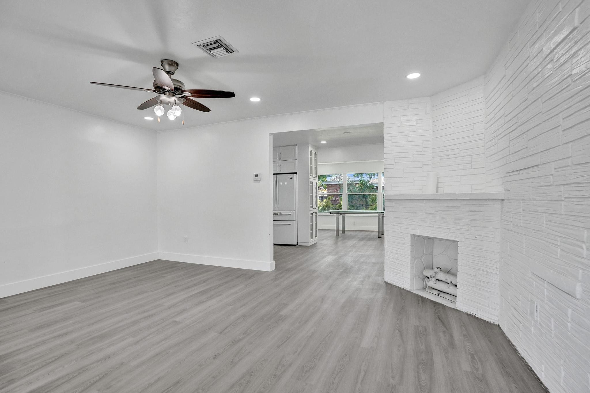 7341 Meridian Street Miramar, FL 33023 - Photo 13 of 74 a view of empty room with wooden floor and fireplace