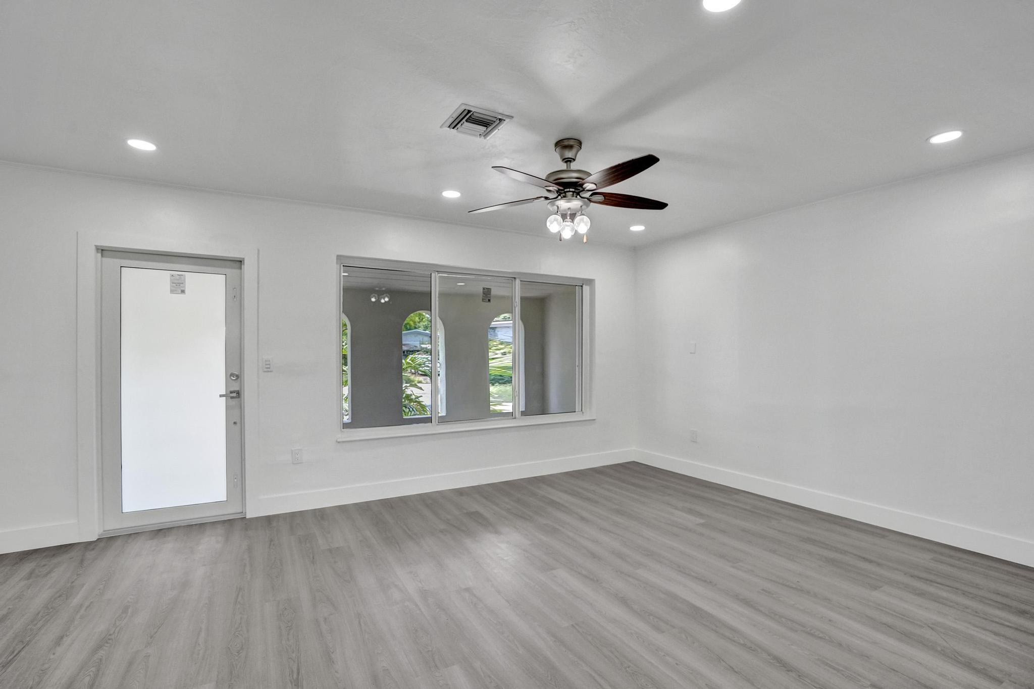 7341 Meridian Street Miramar, FL 33023 - Photo 19 of 74 a view of an empty room with a window and wooden floor