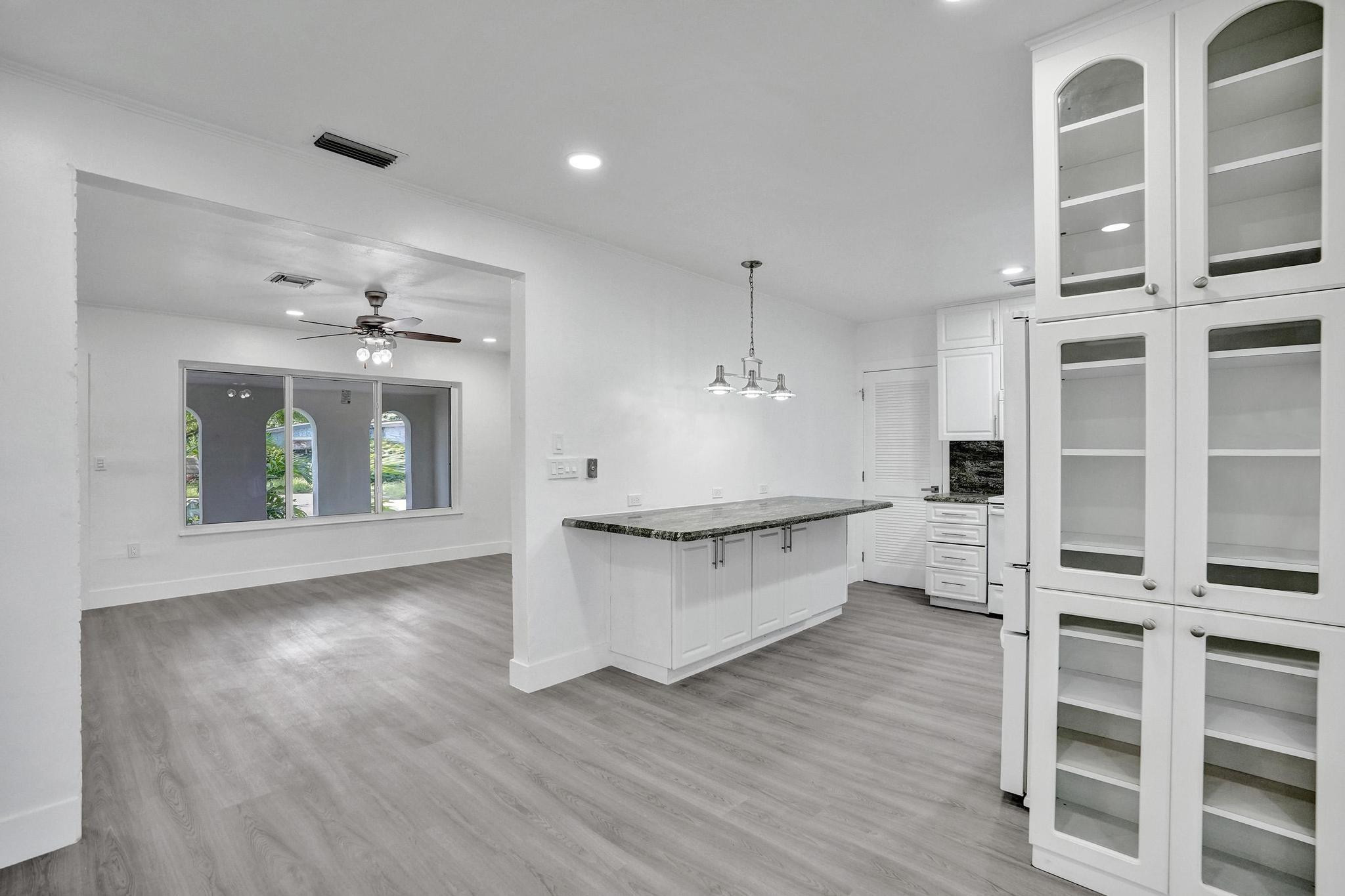 7341 Meridian Street Miramar, FL 33023 - Photo 25 of 74 a open kitchen with white cabinets and wooden floor
