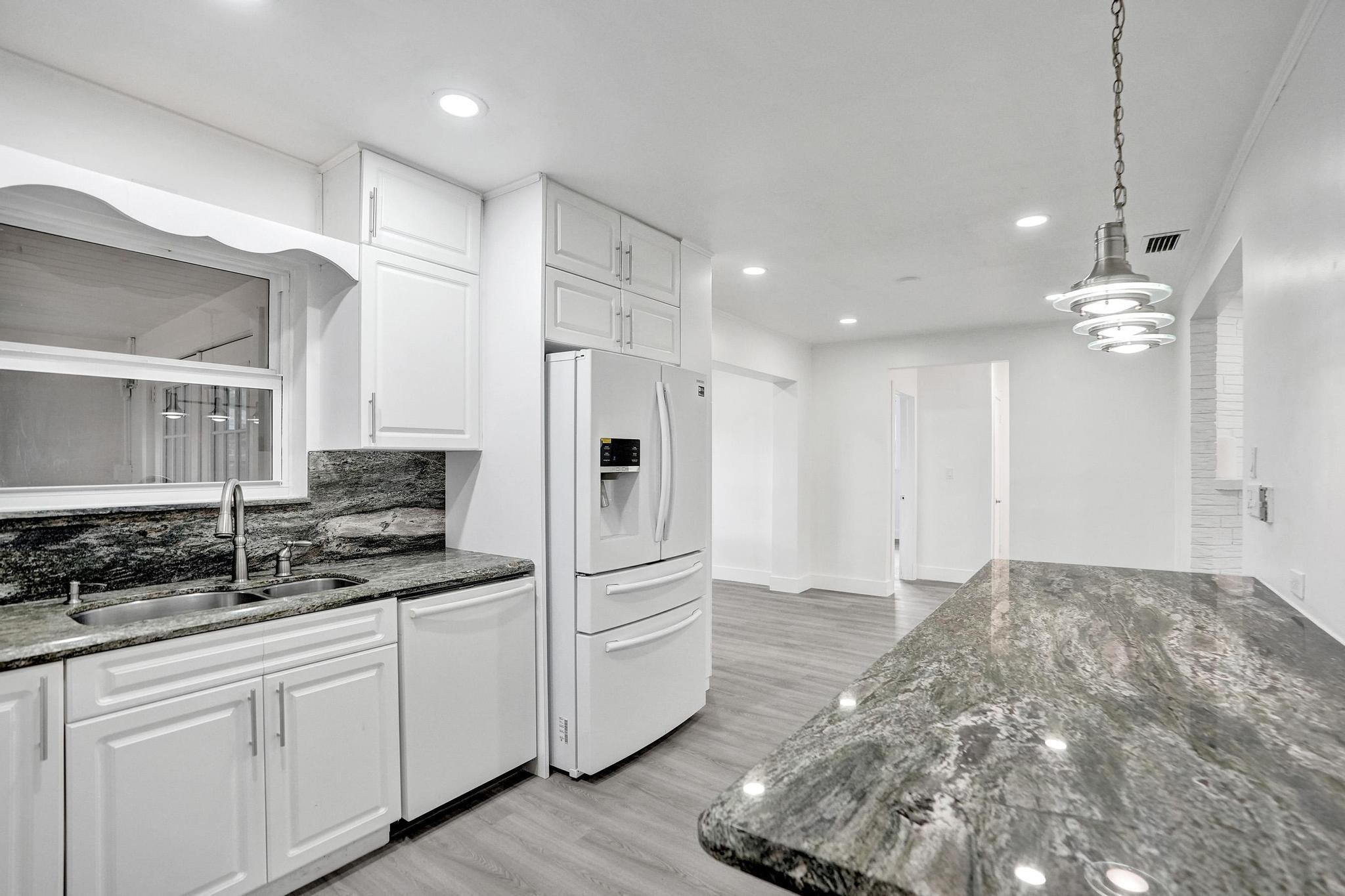 7341 Meridian Street Miramar, FL 33023 - Photo 31 of 74 a large white kitchen with a sink and cabinets