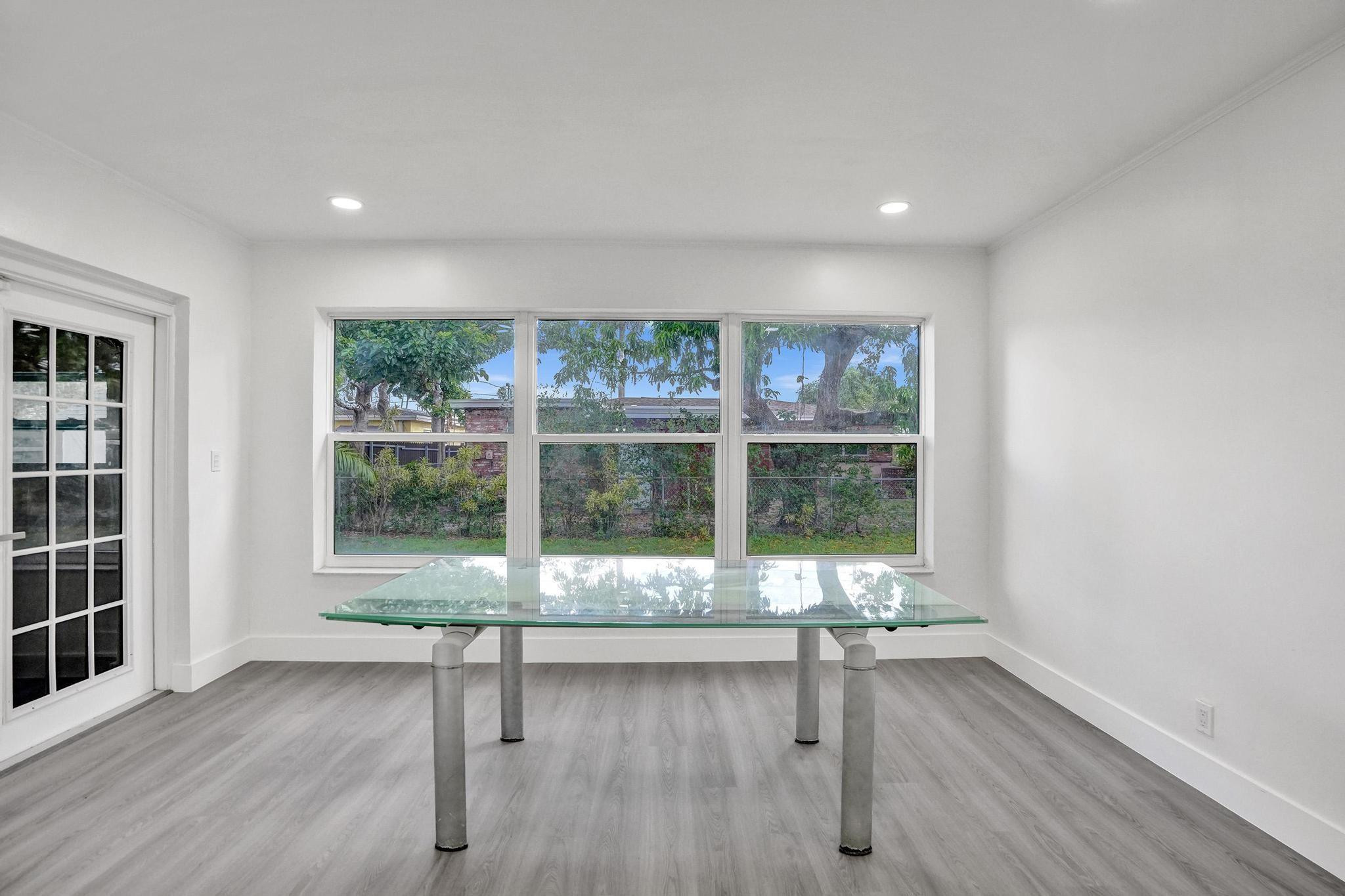 7341 Meridian Street Miramar, FL 33023 - Photo 33 of 74 a living room with wooden floor and glass door