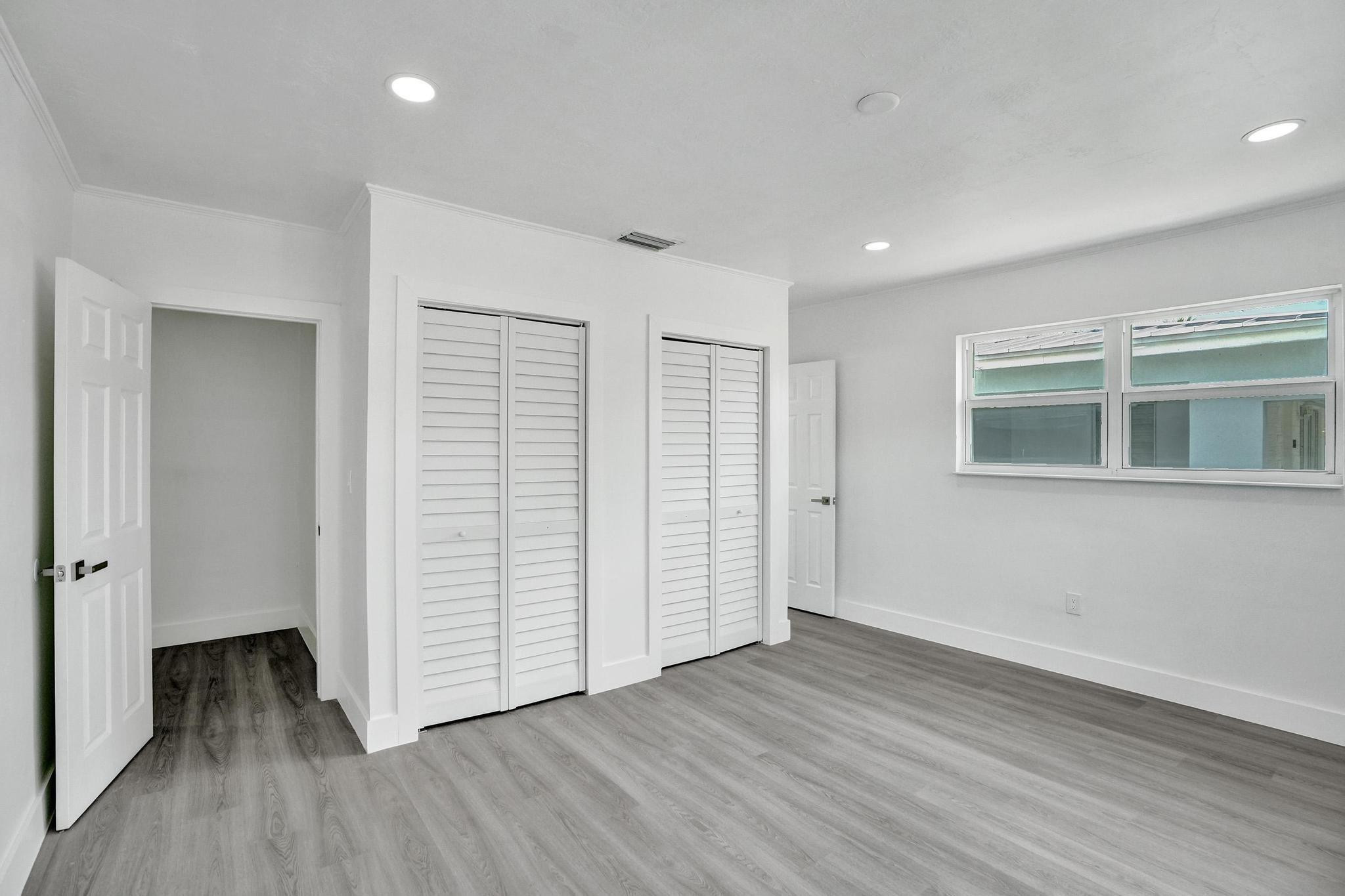 7341 Meridian Street Miramar, FL 33023 - Photo 4 of 74 an empty room with wooden floor & cabinet and a window