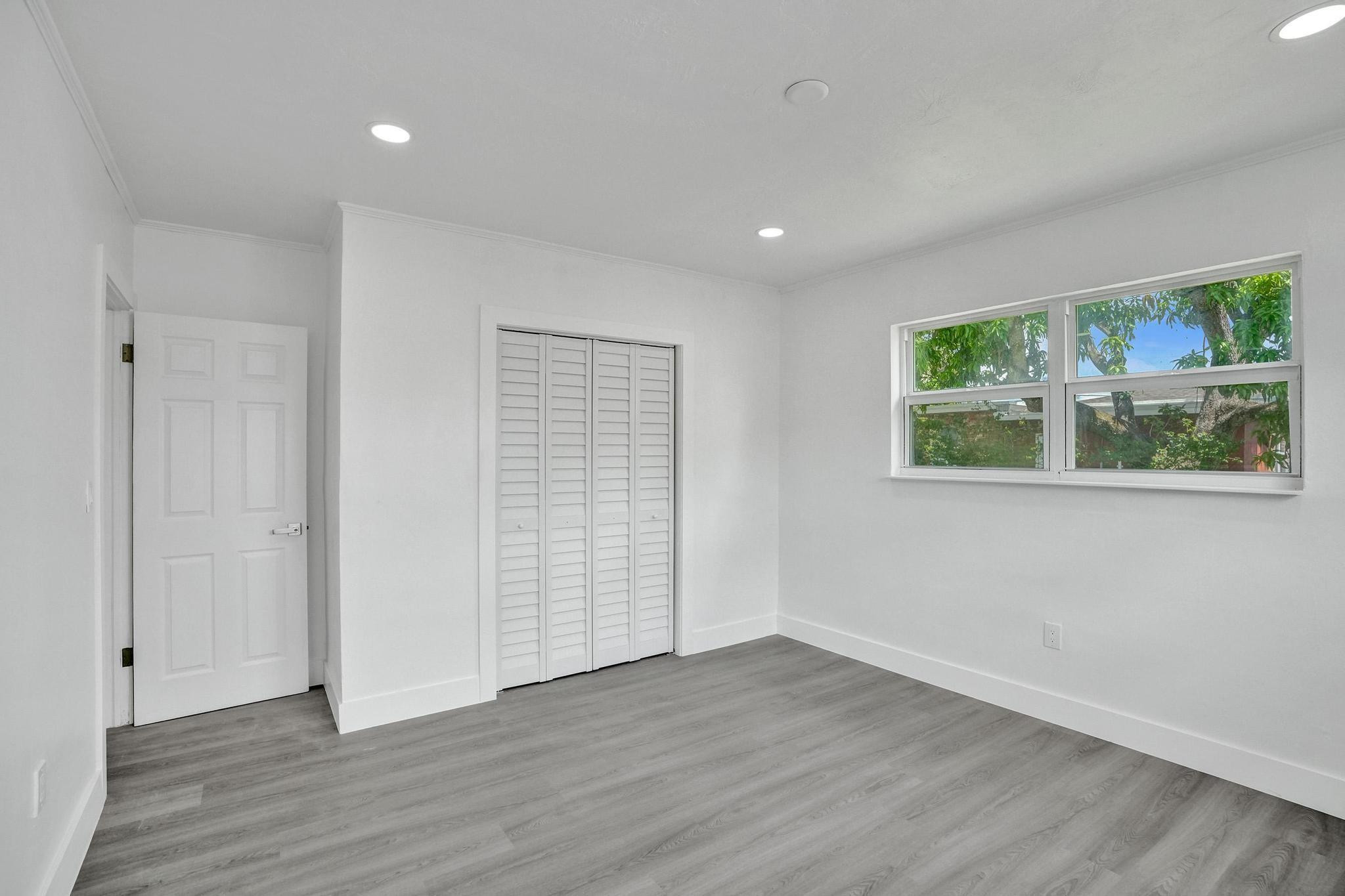 7341 Meridian Street Miramar, FL 33023 - Photo 45 of 74 a view of an empty room with wooden floor and window