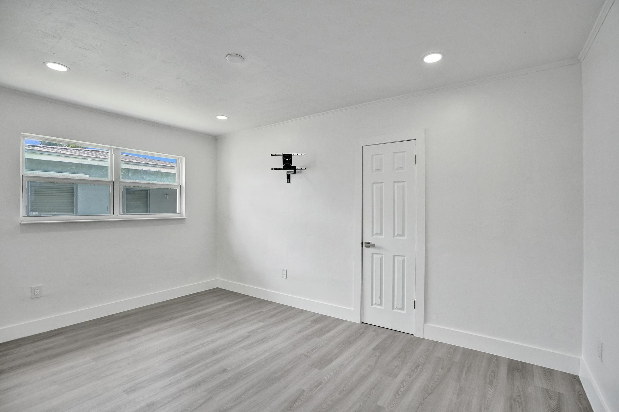7341 Meridian Street Miramar, FL 33023 - Photo 51 of 74 a view of an empty room with wooden floor and windows