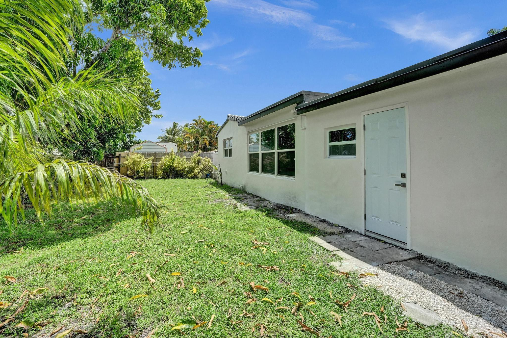 7341 Meridian Street Miramar, FL 33023 - Photo 69 of 74 a backyard of a house with large trees and plants