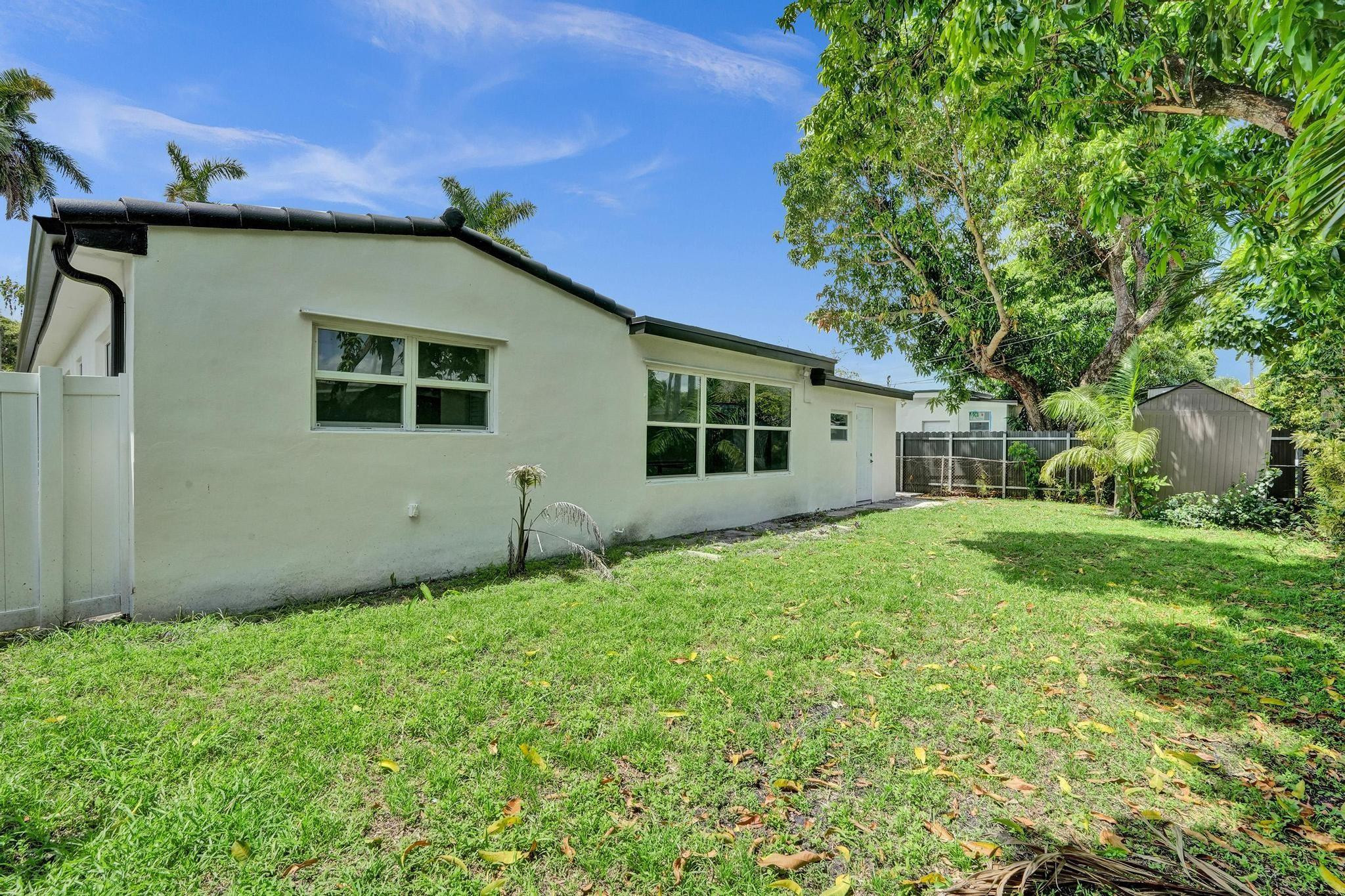7341 Meridian Street Miramar, FL 33023 - Photo 70 of 74 a backyard of a house with plants and large tree