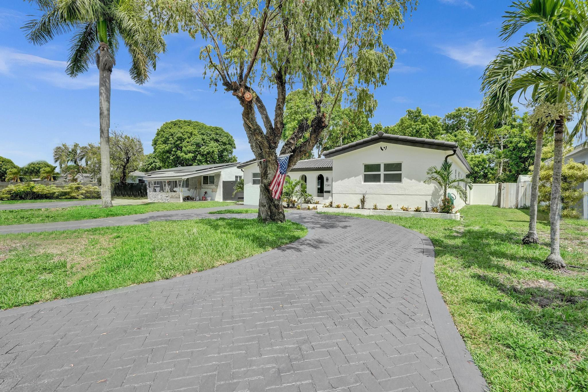 7341 Meridian Street Miramar, FL 33023 - Photo 72 of 74 a front view of a house with garden
