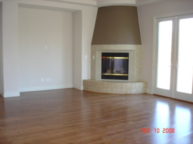 10000 Burghley Lane Reno, NV 89521 - Photo 3 of 9 a view of an empty room with wooden floor fireplace and a window