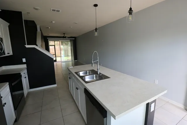 a kitchen with sink stove and refrigerator