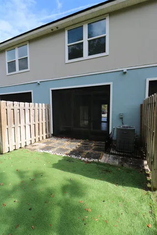 a backyard of a house with yard table and chairs