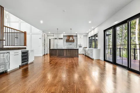 a view of a kitchen with wooden floor and a kitchen