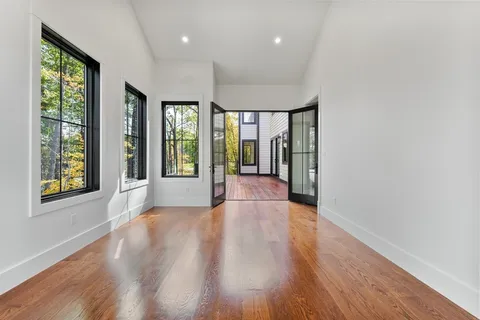 a view of an entryway with wooden floor and door