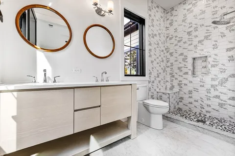 a bathroom with a toilet a sink and a mirror