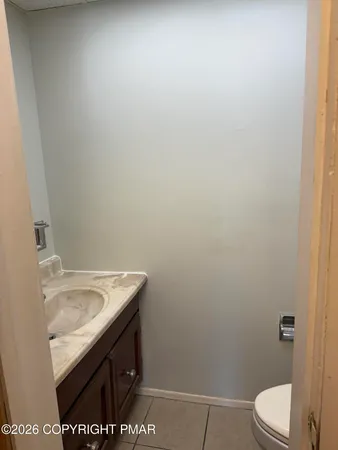 a bathroom with a sink a toilet and vanity