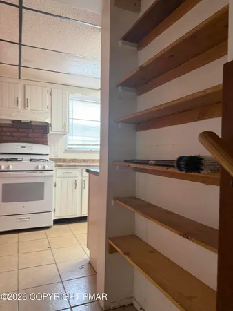a kitchen with white cabinets and white appliances
