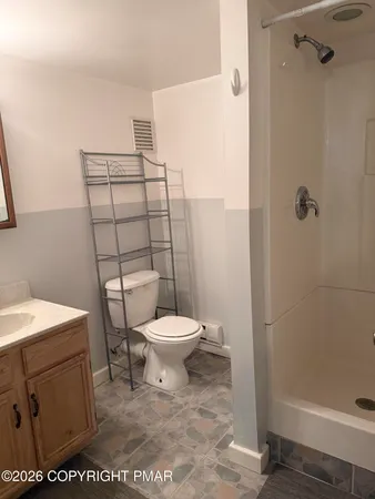 a white toilet sitting next to a bathroom sink