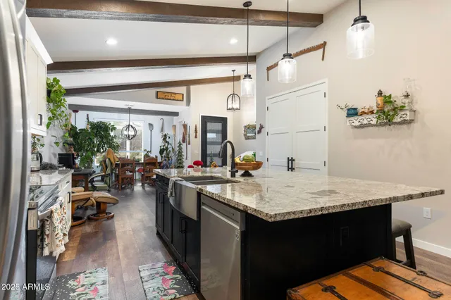 a kitchen with sink cabinets and living room view