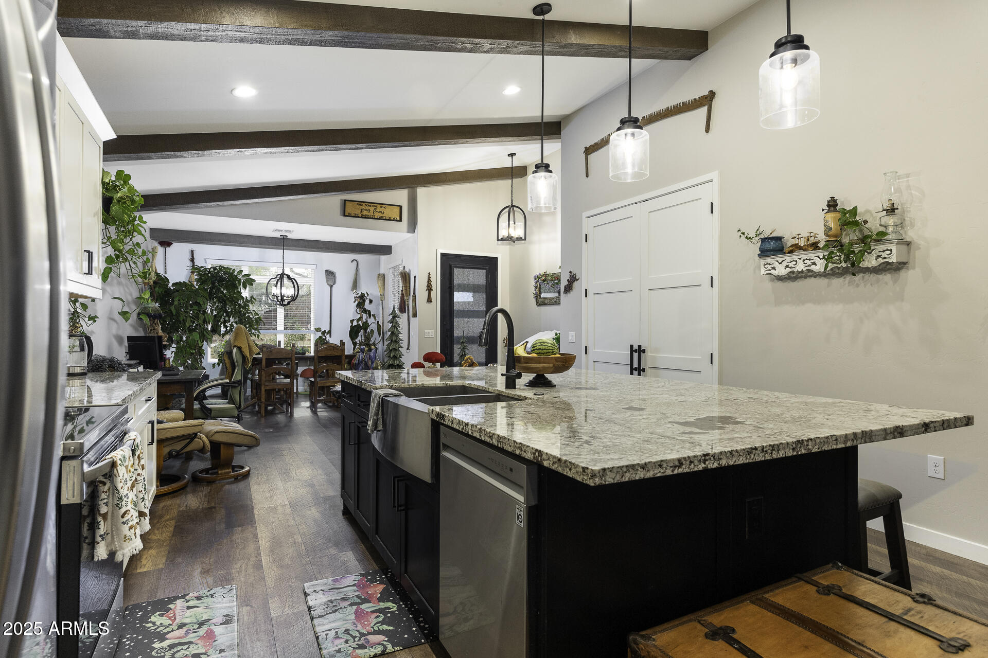 943 East Kortsen Road, Unit 2 Casa Grande, AZ 85122 - Photo 11 of 43 a kitchen with sink cabinets and living room view