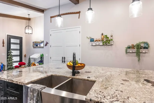 a kitchen view with granite countertop a sink stainless steel appliances and cabinets