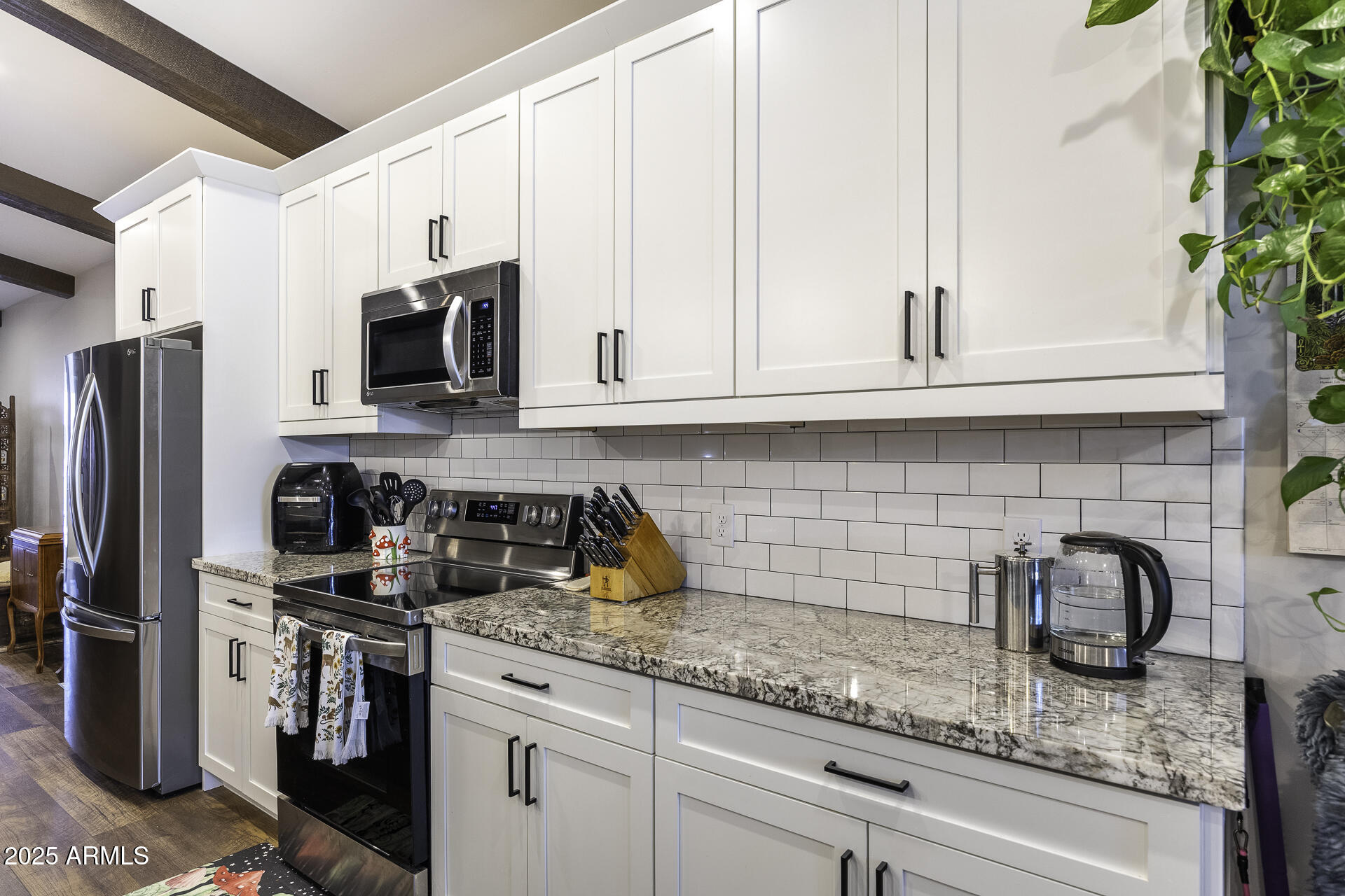 943 East Kortsen Road, Unit 2 Casa Grande, AZ 85122 - Photo 13 of 43 a kitchen with stainless steel appliances granite countertop a refrigerator a stove a sink and dishwasher