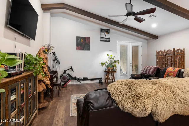 a bed room with a bed window and a flat screen tv