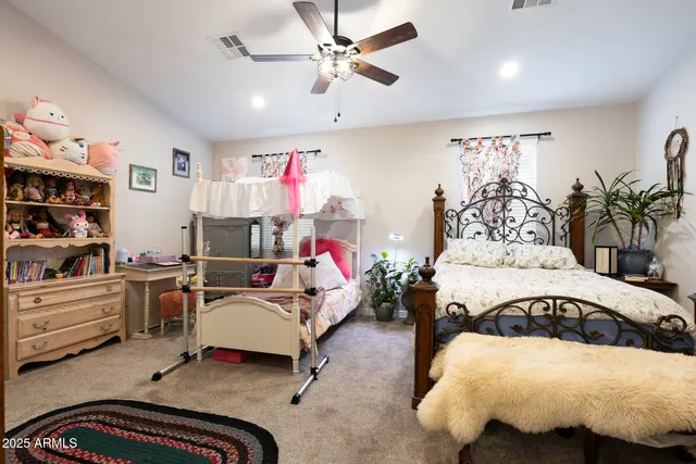 a bedroom with furniture and a chandelier