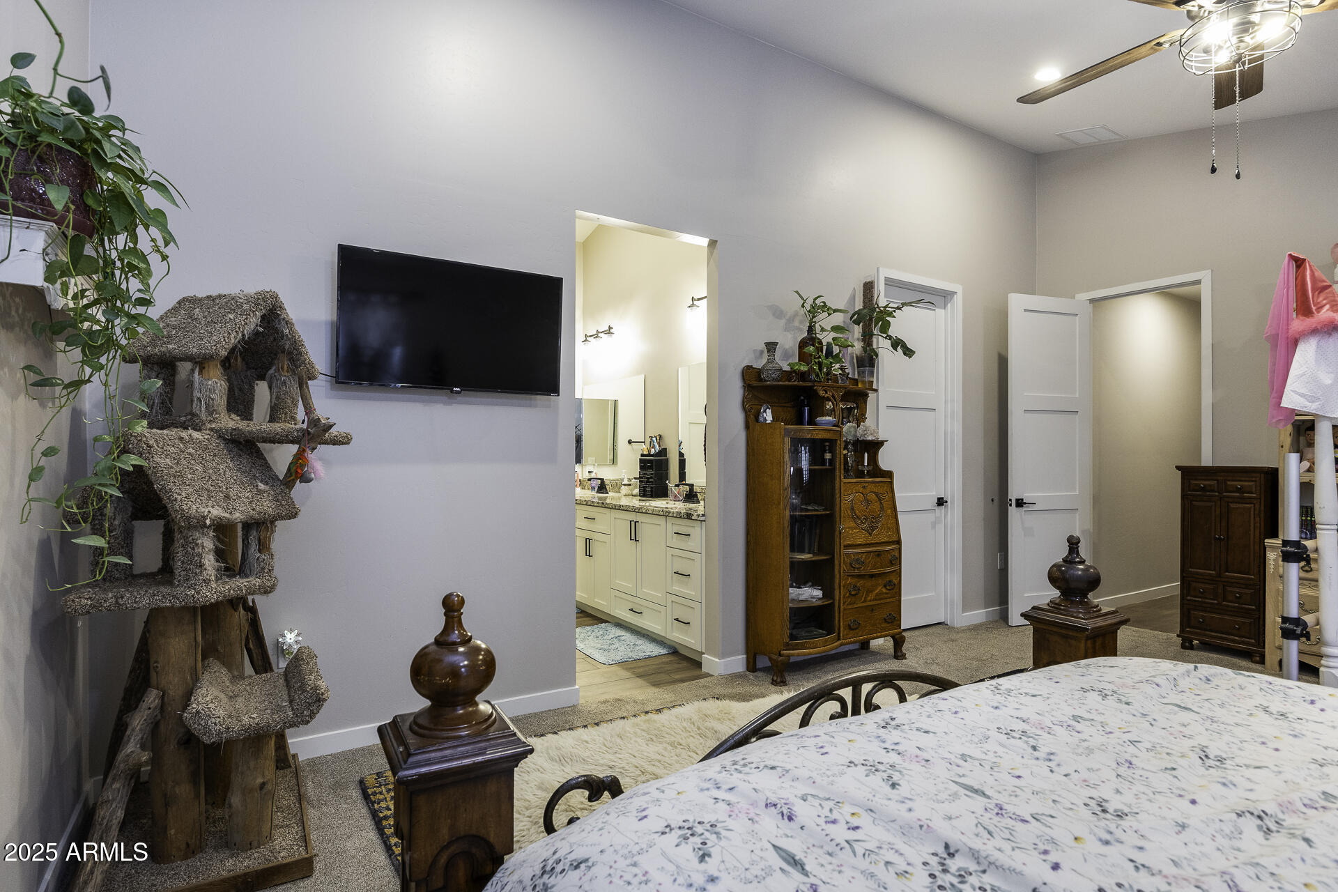 943 East Kortsen Road, Unit 2 Casa Grande, AZ 85122 - Photo 23 of 43 a bedroom with furniture a flat screen tv and a potted plant