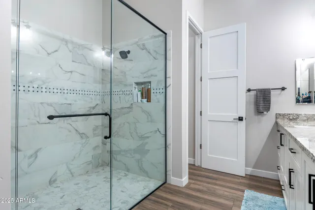 a bathroom with a shower and a sink