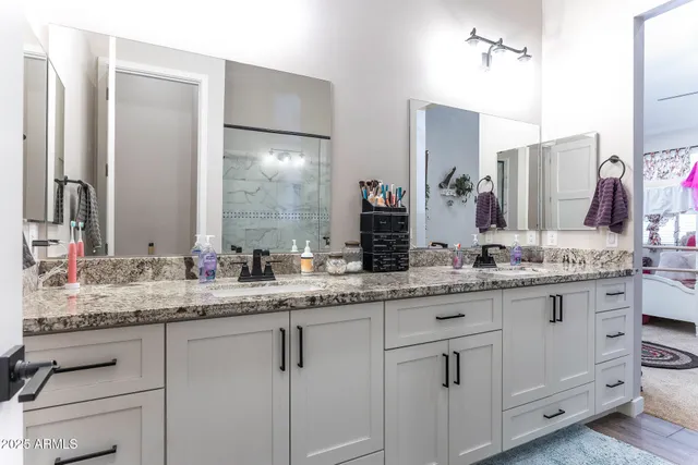 a bathroom with a granite countertop sink and a mirror