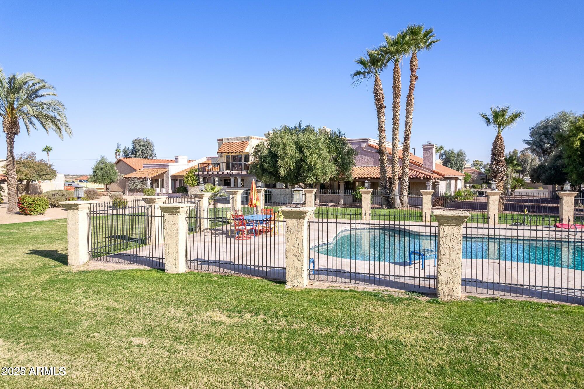 943 East Kortsen Road, Unit 2 Casa Grande, AZ 85122 - Photo 41 of 43 a view of swimming pool with a bench and palm trees