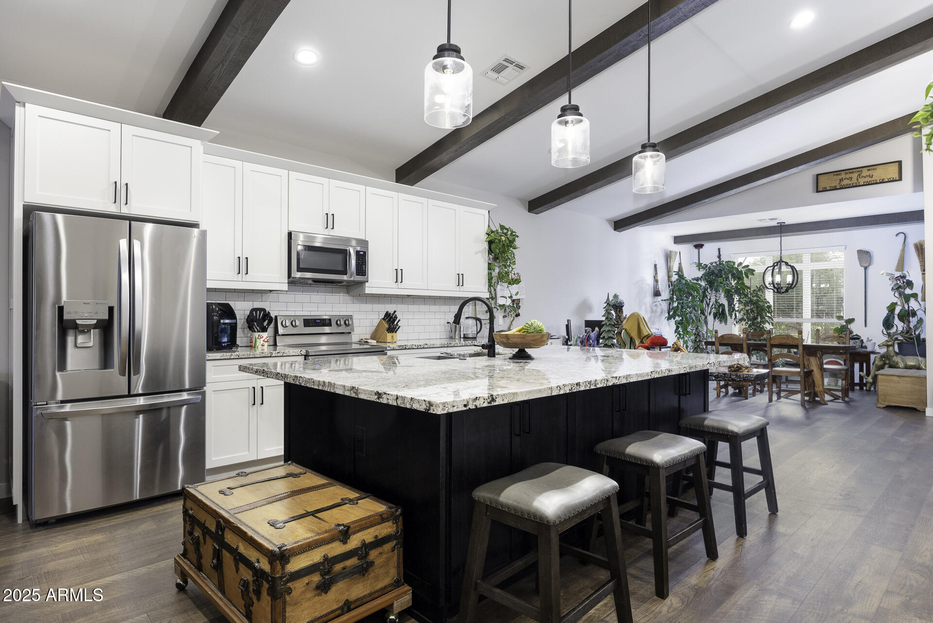 943 East Kortsen Road, Unit 2 Casa Grande, AZ 85122 - Photo 10 of 43 a kitchen with stainless steel appliances granite countertop a sink a stove a refrigerator cabinets and chairs
