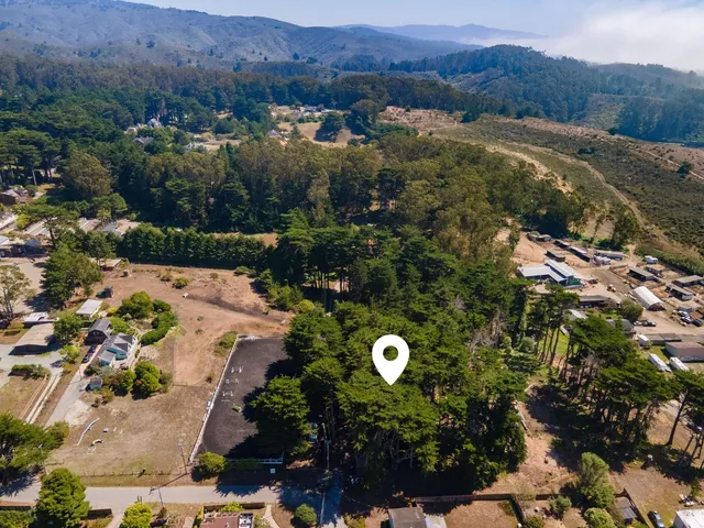 an aerial view of a house and mountain view