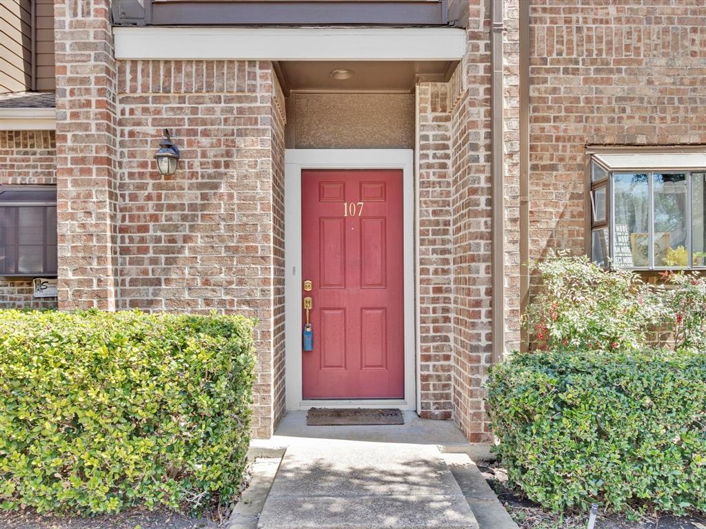 5859 Frankford Road, Unit 107 Dallas, TX 75252 - Photo 1 of 1 a front view of a house with a garden