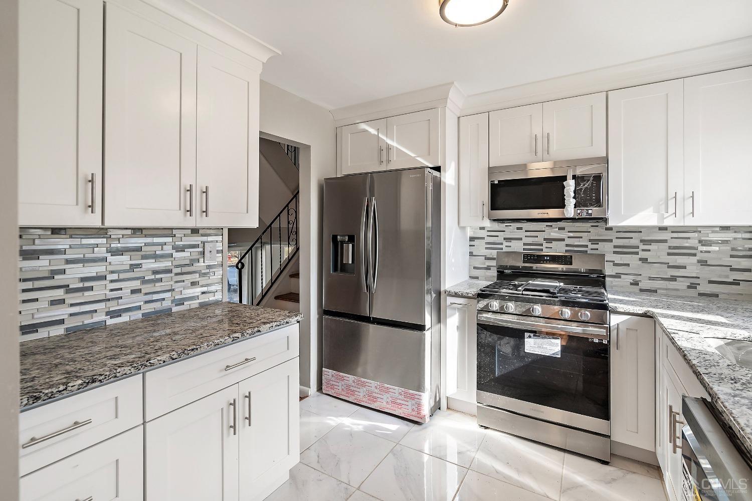 11 Hill Road Edison, NJ 08817 - Photo 14 of 24 a kitchen with granite countertop a stove microwave and refrigerator