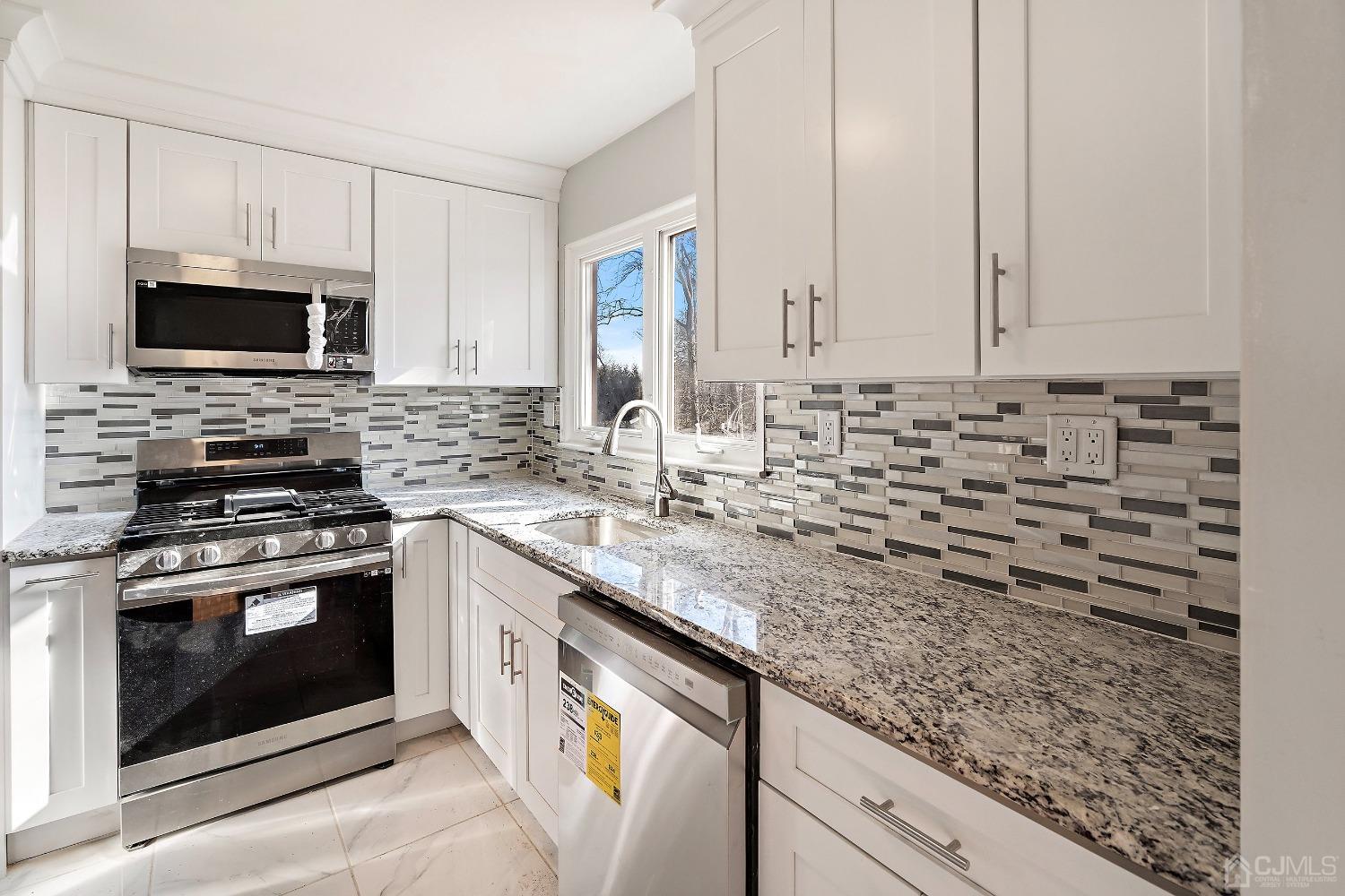 11 Hill Road Edison, NJ 08817 - Photo 15 of 24 a kitchen with stainless steel appliances granite countertop a sink stove and microwave