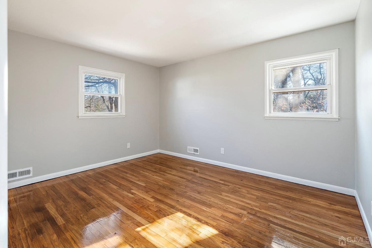 11 Hill Road Edison, NJ 08817 - Photo 20 of 24 a view of an empty room with wooden floor and a window