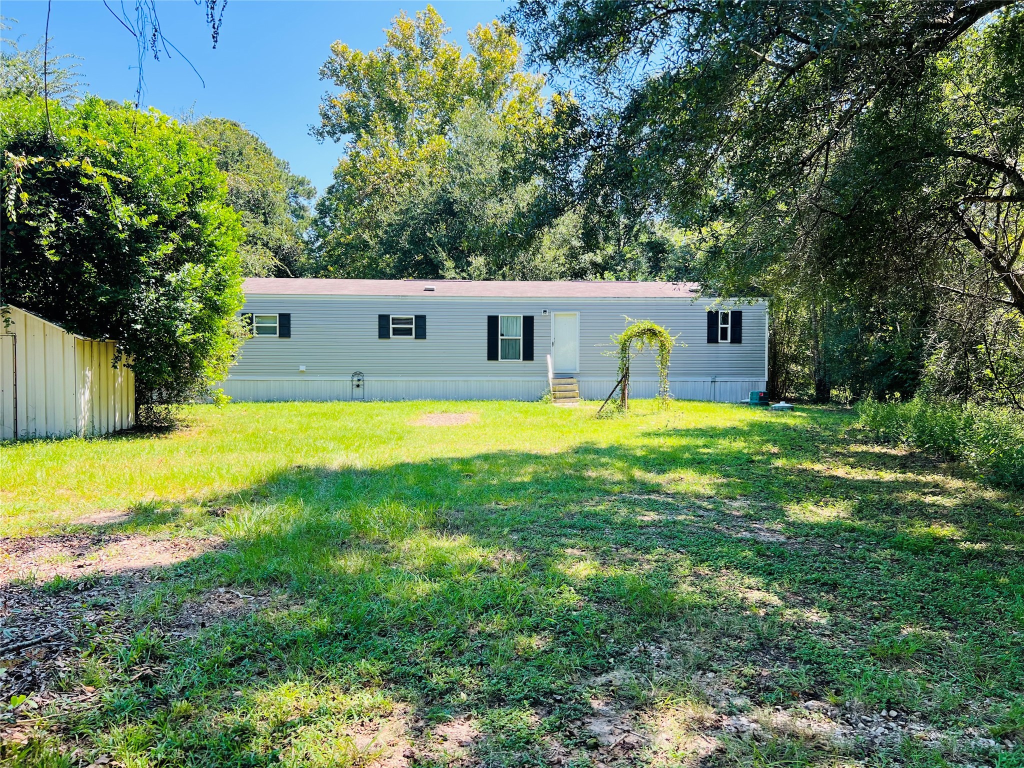 a swimming pool with a lawn chairs and plants