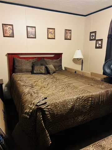 a large bed sitting in a bedroom next to a wall with a rug