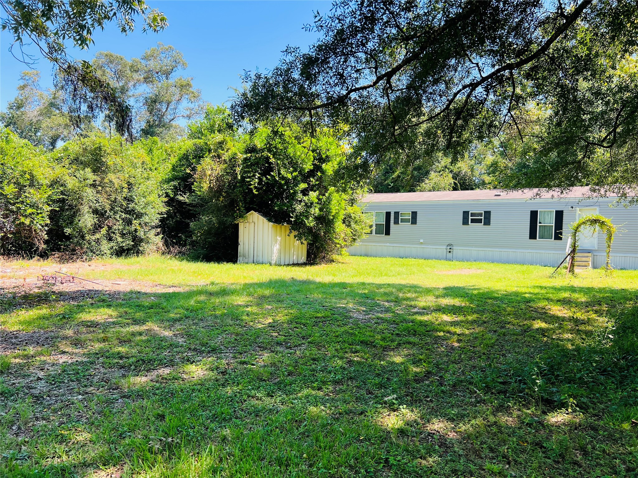 73 County Road 3703 Splendora, TX 77372 - Photo 2 of 14 a view of a swimming pool with an outdoor seating and a yard