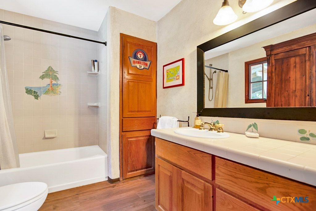 541 Martindale Falls Road Martindale, TX 78655 - Photo 19 of 44 a bathroom with a tub sink and mirror