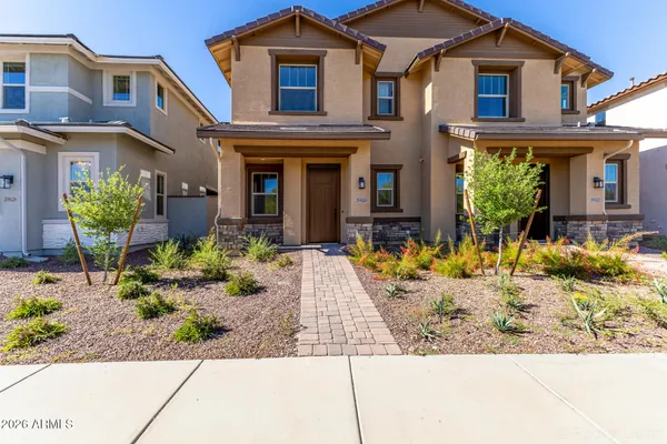 a front view of a house with lots of potted plants