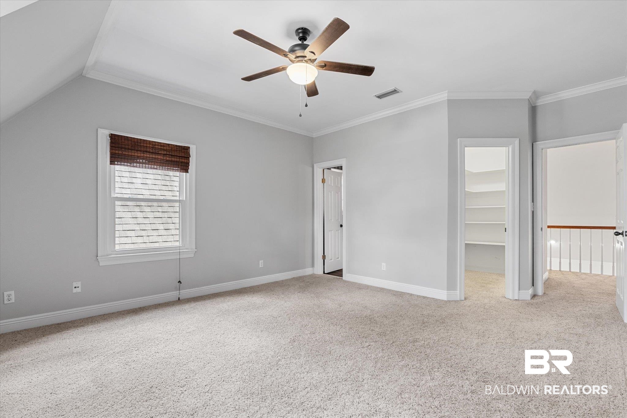 5231 Dawes Road Grand Bay, AL 36541 - Photo 24 of 49 Unfurnished bedroom with lofted ceiling, carpet floors, a walk in closet, ornamental molding, and ceiling fan