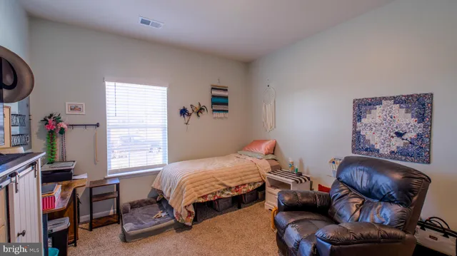 a bedroom with furniture and a window
