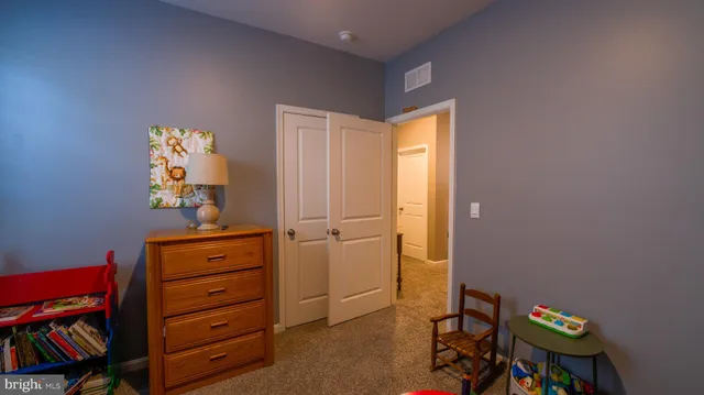 a bedroom with a bed and a dresser in it