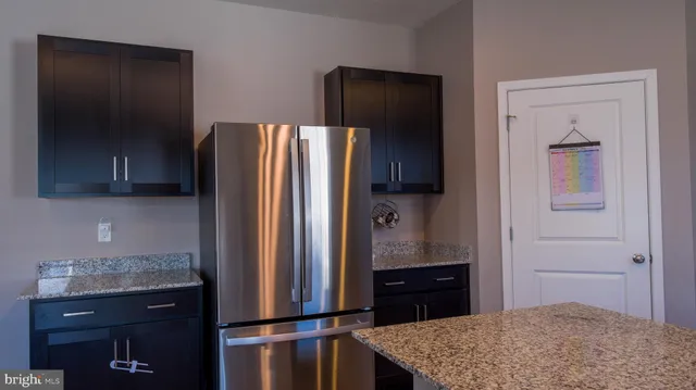a kitchen with a refrigerator and cabinets